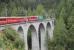 The amazing loops, spirals, tunnels and viaducts of the Rhaeitian Railway Albula line have been made a UNESCO world heritage site. Ge 4/4 III electric loco No. 647 <I>Grusch</I> crosses one of many tall slender structures on a Chur to St. Moritz train shortly after leaving Bergun. <br><br>[Mark Bartlett 16/09/2013]