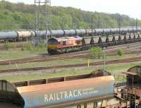 EWS 66063 about to exit Tyne Yard in May 2006 with northbound coal empties, as a ballast train enters the yard in the foreground.<br><br>[John Furnevel /05/2006]