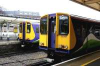 A pair of Silverlink class 313 dual voltage electric units standing side by side in the rain at Richmond's North London Line platforms 3 and 4 in July 2005. Platforms 5-7 beyond are used by District Line trains. This was the period when NLL services were running through to North Woolwich. [see image 5174]<br><br>[John Furnevel 22/07/2005]