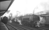 A steamy south end of Carlisle station on 21 December 1963. The Stanier Pacific on the centre road nearest the camera is 46248 <I>City of Leeds</I>, waiting to relieve the incoming locomotive off the 10.10am Edinburgh Princes Street - Birmingham New Street.<br><br>[K A Gray 21/12/1963]
