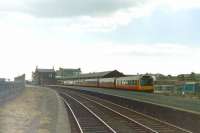 Platform view west at Ardrossan Town in 1985, looking back towards the station entrance on Princes Street [see image 29408]. A 6-car DMU is stabled in the bay platform. The station, which was closed at that time, reopened following electrification in January 1987.  <br><br>[Colin Miller //1985]