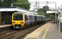 A Northern service from Crewe to Manchester Piccadilly via the Airport calls at Wilmslow on 3 October 2013.<br><br>[John McIntyre 03/10/2013]