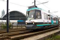 One of the first generation Metrolink trams, bound for Eccles, passes the former Manchester Central station on 4 October as it approaches the Deansgate Castlefields tram stop.<br><br>[John McIntyre 04/10/2013]