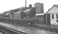 A wet day at Nine Elms in August 1961 sees Billinton E4 radial 0-6-2T  no 32473 of 1894 stabled on the south side of the shed yard. Standing behind is relative youngster Wainwright C class 0-6-0 no 31510 of 1904. No 32473 was subsequently preserved on the Bluebell Railway [see image 38400].<br><br>[K A Gray 21/08/1961]