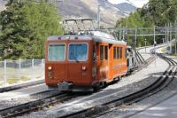 Two overhead wires are used on the Gornergrat rack railway for its 3-phase power supply and the twin pantographs on the EMUs are joined by an insulator. A section of line nearer the summit is presently being doubled on a new formation resulting in much works traffic. Car 3052 is seen here at Riffelalp descending with a fuel tanker which will transfer to the MGB line in Zermatt and be collected by the branch goods train.<br><br>[Mark Bartlett 12/09/2013]