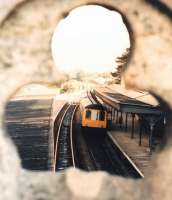 A Birmingham-bound DMU spotted through the parapet of the road bridge at Great Malvern in 1988.<br><br>[Ken Strachan //1988]