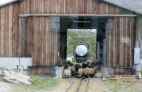 Despite the temporary occupants, this goods shed, high on the mountainside at Riffelboden, is in regular use supplying all the requirements for the construction of the Gornergratbahn's new double track section. Later that day the fuel tanker was taken down the line for reloading [See image 45082]. Grab shot from passing passenger train.<br><br>[Mark Bartlett 12/09/2013]