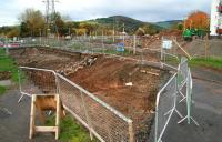 The currently closed Winston Road in Galashiels, on 24 October 2013, looking north west over the section of road that once bridged the Waverley route. The trackbed follows the re-excavated cutting beyond in the general direction of Galashiels station [see image 44759].<br><br>[John Furnevel 24/10/2013]