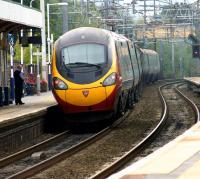 A Manchester Piccadilly - London Euston (via Crewe) Pendolino snakes away from a station stop at Wilmslow on 3 October 2013.<br><br>[John McIntyre 03/10/2013]