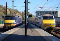 East Coast 91121 propels empty stock out of Waverley Station towards Craigentinny Depot on 29 October past sleeper locomotive 90024 standing in the bay.<br><br>[Bill Roberton 29/10/2013]