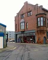 The restored former Andrew Barclay Works in Kilmarnock, with mixed guage tracks still in place across the public road. A Barclay saddle tank, one of hundreds built here over the years, is displayed inside the building and just visible in this picture. [See image 39875] for a close up view.<br><br>[Malcolm Chattwood 26/10/2013]