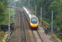 A southbound Pendolino has just passed the site of Standish Junction (Lancashire) as it heads towards Wigan on 3 October. The bridge under the front of the Pendolino used to carry the down line from the Whelley Loop around Wigan.<br><br>[John McIntyre 03/10/2013]