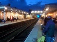 Looking North at Loughborough at dusk in October 2013. I decided not to include a train in the picture, as the flash could distract the driver. It is hard to tell from this distance that the footbridge is much more recent than the station. The chap on the right with the folding bike is clearly a multimodal transport enthusiast.<br><br>[Ken Strachan 25/10/2013]