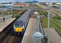View east from the footbridge at Edinburgh Park station on 8 October 2013 as 334036 arrives with a service for the Bathgate line.<br><br>[Bill Roberton 08/10/2013]