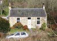 Station House, Auchendinny, photographed looking north west from the B7026 in April 2013. The lane leading down to the station site (now part of a walkway) runs past the front of the cottage. [See image 42973]  <br><br>[John Furnevel 24/04/2013]