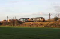 Two different DRS liveries (both now being replaced as locos are overhauled), lit by an early morning autumn sun at Oubeck Loops on 30 October as the Crewe to Sellafield flasks head north behind 37038 and 37602.<br><br>[Mark Bartlett 30/10/2013]