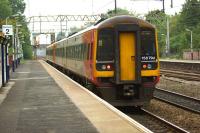 Ultimate destination Liverpool Lime Street - a pair of East Midlands class 158 DMUs passes Heaton Chapel station heading towards Piccadilly on 3 October 2013.<br><br>[John McIntyre 03/10/2013]