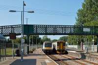 In December 2012, a passing loop was brought into use at Beccles on the East Suffolk line to allow up and down trains to occupy the section between Oulton Broad and Halesworth at the same time. Previously, this had not been possible since 1985 when the section was singled. The loop has permitted the service between Saxmundham and Lowestoft (and vice versa) to become hourly instead of two hourly, a major improvement for regular users. Shown here are Lowestoft and Ipswich services crossing at Beccles on 8th July 2013.<br><br>[Mark Dufton 08/07/2013]