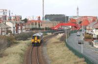 It's <I>Movember</I>. Northern Rail is supporting the men's health charity but its not just the staff who are growing facial hair. Sprinter 150215, seen here leaving Blackpool Pleasure Beach, is one of a number sporting <I>moustaches</I> on the gangway doors this month. <br><br>[Mark Bartlett 13/11/2013]