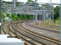 Looking east at Arkleston Junction in June 2013. The signal box stood in the centre of the picture on the left-hand side of the cutting and the pointwork was mostly in that area, starting under the Arkleston Road bridge in the distance - beyond which stood a large signal gantry. Nowadays the switches extend well beyond the bridge, culminating in a reduction from four tracks to three well on the way to Hillington West. I am not sure if you could class this as Arkleston Junction any longer.<br><br>[Colin Miller 24/06/2013]