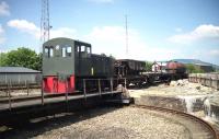 An NBL built 0-4-0 DH shunter stands on the turntable at Aviemore on the Strathspey Railway in July 1991. The pit had been filled in after the shed closed in BR days and the mechanical parts were subsequently recovered from Kyle of Lochalsh.<br><br>[John McIntyre /07/1991]