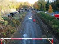 Looking north from the B6392 road bridge along the Waverley trackbed towards Glenesk Junction on Sunday 17 November 2013. The pipes on the left are stored on the site of the sidings that once served the former Glenesk Colliery. [See image 43207]<br><br>[John Furnevel 17/11/2013]