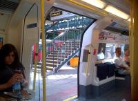 The stairs to platforms 2 and 3 are framed in the doorway as a Northern line service prepares for departure from High Barnet on 12 July 2013.<br><br>[Ken Strachan 12/07/2013]