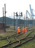 Looking west towards Norwich from Lowestoft station in January 2005 with a 'discussion group' meeting in the sidings alongside the docks.<br><br>[Ian Dinmore /01/2005]