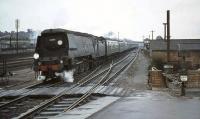 Battle of Britain Pacific 34051 <I>Winston Churchill</I> about to enter Basingstoke in the summer of 1964 with a Waterloo - Bournemouth West train.<br><br>[John Robin 24/08/1964]