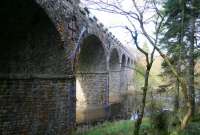 Looking north over the Kielder Burn alongside the viaduct on 5 November 2013.  The Border Counties line continued north west from here before eventually meeting up with the Waverley route at Riccarton Junction.<br><br>[John Furnevel 05/11/2013]