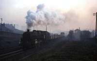 Standard class 5 4-6-0 no 73101 pulls away from Pollokshaws yard with a freight on a foggy evening in March 1963. Pollokshaws North signal box stands on the right. <br><br>[John Robin 11/03/1963]