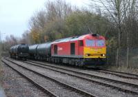 The bitumen tanks for Preston Dock are presently routed via Manchester Victoria and Parkside due to the Copy Pit route being closed until March 2014 (See news item). Refurbished DBS 60017 arrives in the exchange sidings on 27 November with the loaded tanks, running alongside the empties waiting to be returned.<br><br>[Mark Bartlett 27/11/2013]