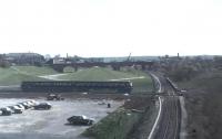 Bury and Manchester line EMU (Class 504) leaving Bury Interchange in 1981 and about to cross at right angles the surviving track of the Castleton to Bury line and bisect the former Knowsley Street platform. The 1970s <I>landscaping</I> was on the site of the old Knowsley St goods yard and the bridge in the background gives an indication of the number of tracks that once existed at this location. <br><br>[Mark Bartlett 14/02/1981]