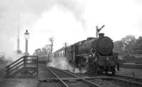 Black 5 44992 about to collect the tablet from the signalman alongside Busby box in May 1964 with a train of empty stock bound for East Kilbride.<br><br>[John Robin 30/05/1964]