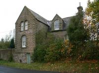 The 1861 station building at Bellingham looking north across Redesmouth Road (leading to Reedsmouth Station) on 6 November 2013. Note the bricked up pedestrian entrance alongside to the left. If anything, the old building looks even creepier from this side [see image 17629].<br><br>[John Furnevel 06/11/2013]