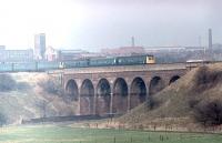 The <I>Rossendale Farewell</I> Railtour, a 6-car DMU, on the return run from Rawtenstall to Manchester crossing the River Roch at Heap Bridge. Although there were high hopes at this time for re-opening from Bury to Rawtenstall I little thought that this stretch of line from Bury to Castleton would also see East Lancashire Railway trains running again in due course. <br><br>[Mark Bartlett 14/02/1981]