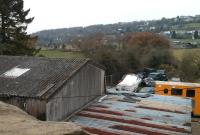 The site of Drybrook Halt looking south in December 2013. The line of the route to Cinderford can be seen centre left above the shed roof. Drybrook Halt was the northern limit of the short-lived passenger services on this line; Drybrook Road on the Severn and Wye Railway was several miles away in the Forest (and not even on a road!). Behind the camera, a new house has been built on the filled-in cutting.<br><br>[John Thorn 03/12/2013]