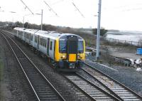On Day 1 of the new timetable TransPennine Express used its own EMU for driver training in place of the hired London Midland set. The almost new and still unliveried 350401 heads north on the coast at Hest Bank on 9 December. These Preston - Carlisle trips are timetabled on an as required basis until May 2014.<br><br>[Mark Bartlett 09/12/2013]
