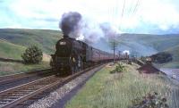 Black 5 44658 has just cleared Harthope Viaduct with a heavy train on the climb to Beattock summit in the summer of 1965. The banker on this occasion is Fairburn tank 42693. <br><br>[John Robin 31/07/1965]