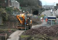 Lights on in a gloomy Galashiels on 10 December 2013, despite it being well after 10am. Construction work is seen underway here just to the north of Ladhope Tunnel.<br><br>[John Furnevel 10/12/2013]