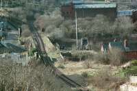 Cartsburn Viaduct and Junction viewed from above in 1988. The view looks west. The line to the right was the relaid Inchgreen branch with a connection laid in to the Wemyss Bay line at Containerbase Junction. The line ahead and to the left was the route from Kilmacolm to Princes Pier closed in 1966. The track was relaid in 1971to serve the Greenock container depot but was in abeyance by 1988.<br><br>[Ewan Crawford //1988]