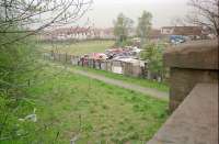 View north over the site of Newmains station on the line between Cleland and Morningside. The goods yard was located where the scrap yard is seen in this 1997 view. The scrap yard site is now housing.<br><br>[Ewan Crawford 03/05/1997]