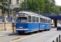 An ex-Vienna tram climbing from under the bridge carrying the main rail lines into Krakow Glowny station on 19 July 2012.<br><br>[Colin Miller 19/07/2012]