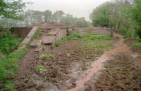 View north towards Causewayend at a rather muddy Bowhouse station in 1997. Bowhouse station closed to passengers in 1930 with the line itself closing completely in 1964. [See image 25421]<br><br>[Ewan Crawford 03/05/1997]