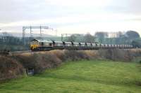 With 19 empty bogie hoppers in tow 66531 heads back to Scotland on a cold December afternoon at Bay Horse. The train originated from Fiddlers Ferry Power Station near Warrington. <br><br>[Mark Bartlett 10/12/2013]