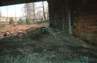 A surviving section of the westbound platform at Comrie, photographed in 1992. View east below the bridge carrying the A85 with a large caravan park now occupying the area beyond. [Ref Query 41097]<br><br>[Ewan Crawford //1992]