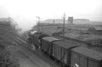 A Black 5 takes the Edinburgh line at Strawfrank Junction (now Carstairs South) with a freight on 29 June 1963. Carstairs MPD stands in the background.<br><br>[John Robin 29/06/1963]