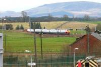 Long lens view east from the footbridge at Carstairs station on Christmas Eve 2005. The northbound Voyager has taken the station avoiding line at Carstairs South Junction and is on its way to Edinburgh. <br><br>[John Furnevel 24/12/2005]