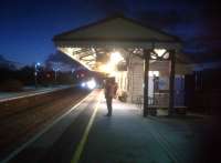 The old railway lives on, here and there. The 15.57 <I>Torbay Express</I> to Paddington arrives at Castle Cary on 27 December 2013. The well maintained, stone built station building retains its old fashioned wooden awning - and two FGW staff came out to meet the train. <br><br>[Ken Strachan 27/12/2013]