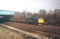 BR Sulzer Type 2 No. 25304 takes a train of fitted vans south on the Up Fast line at Euxton Junction in January 1980. The train is just passing under the M6 Motorway near Junction 28. Built by Beyer Peacock at Gorton in 1966 as D7654, the loco only lasted in service until November 1982 and was eventually cut up at Swindon Works in 1985.  <br><br>[Mark Bartlett 10/01/1980]